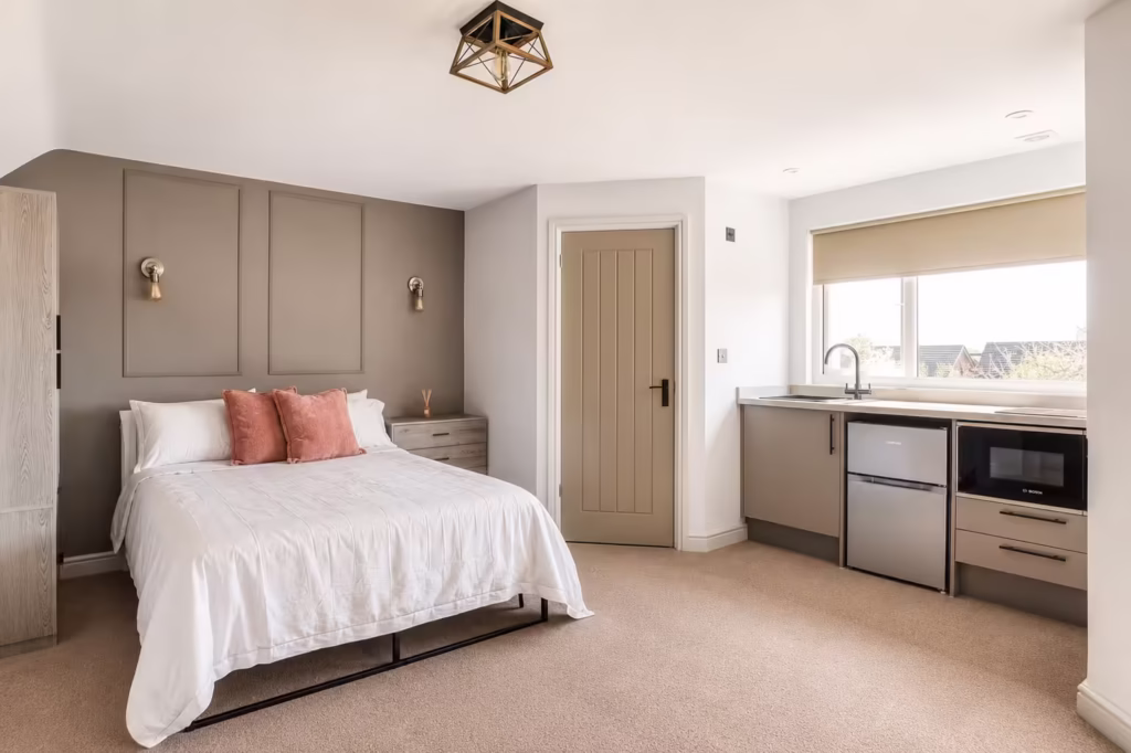 Modern bedroom with kitchenette and double bed