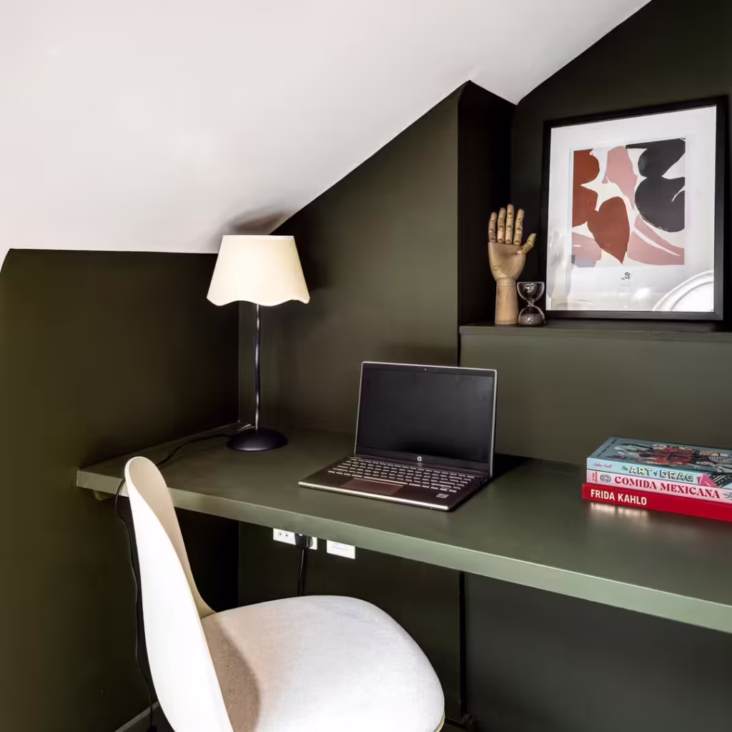 Cosy home office with laptop and books.